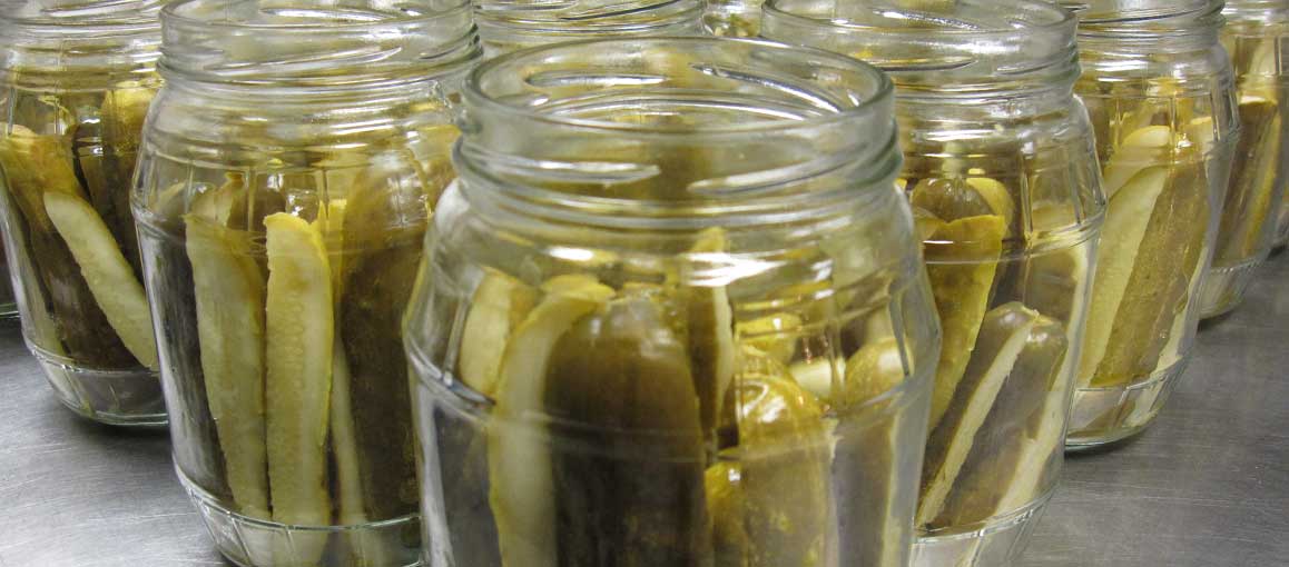 Rows of glass canning jars filled with Bucky's Pickles